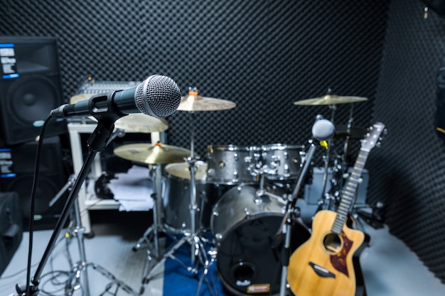 Photo professional condenser studio microphone, musical concept. recording, selective focus  microphone in radio studio, selective focus microphone and blur musical equipment guitar,