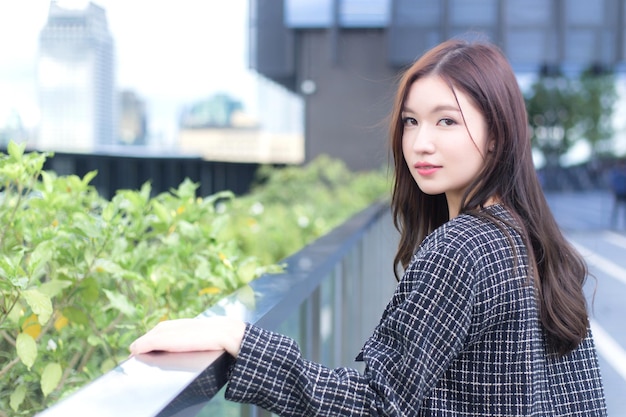 Professional confident working Asian woman who has a long hair wears a black suit black