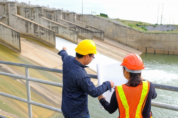 Professional Construction woman engineer Manager wear safety yellow helmet point building 