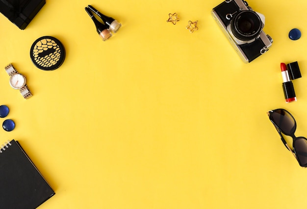 Professional cosmetics and makeup brushes yellow background. Flat lay. Top view