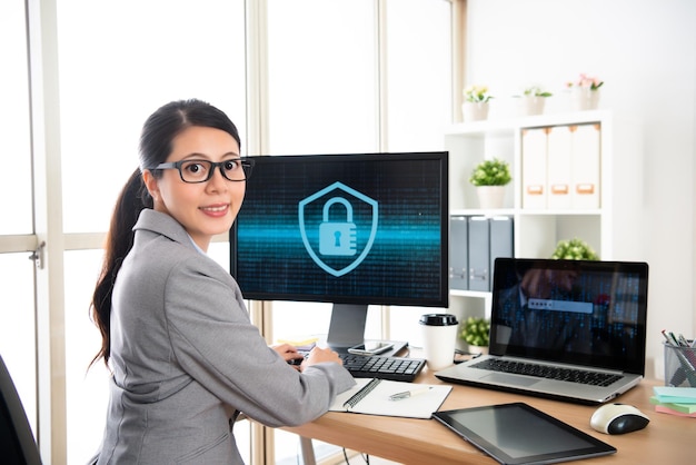 professional cyber security company worker sitting in the office and face to camera smiling.