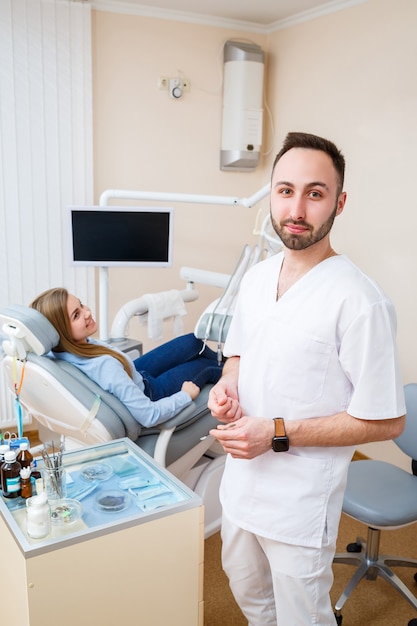 A professional dentist communicates with a woman patient. Dental office for patient examination. Discussion of the dental treatment process.