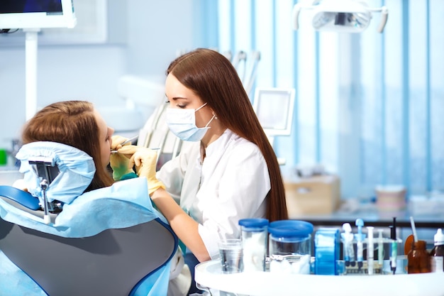 Photo professional dentist doctor working woman at dental clinic lady woman dentist taking care of teeth