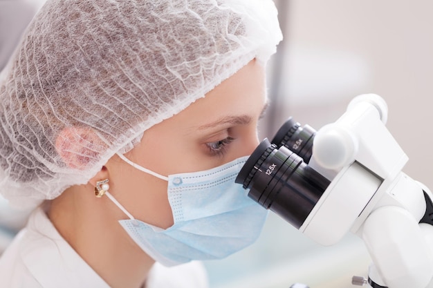 professional dentist examination patient with microscope at the office