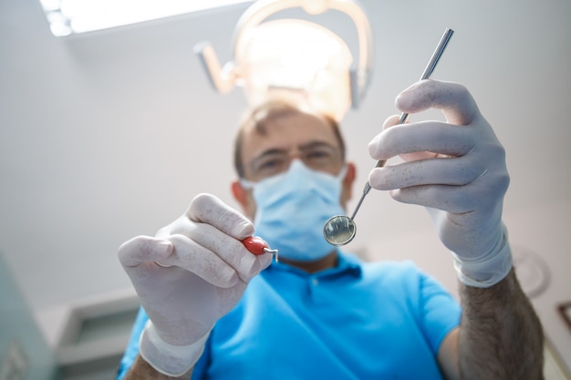 Professional dentist examining patient