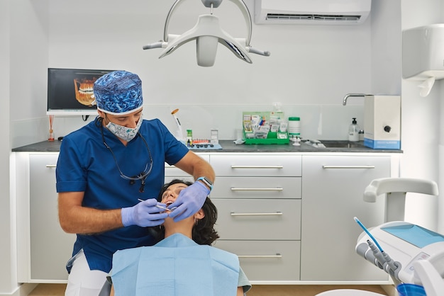 Professional dentist performs a scan on his patient.