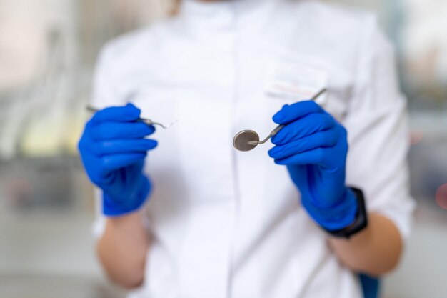 Professional dentistry hands holding tools Close up dentist hands with medical equipment