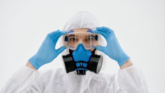 Professional disinfector looking at you through safety glasses