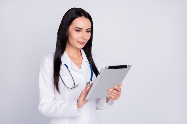 Professional doc lady searching information on tablet