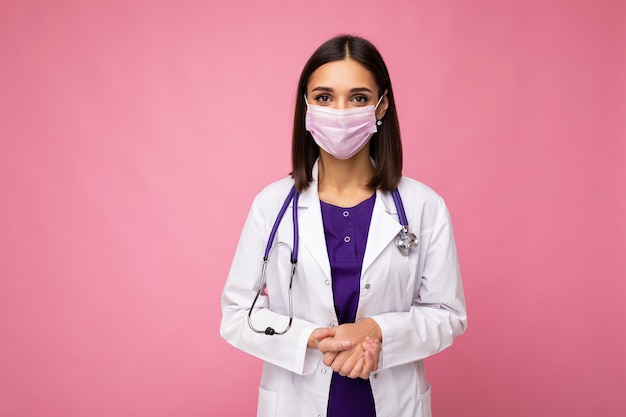 Professional doctor in medical mask and white coat