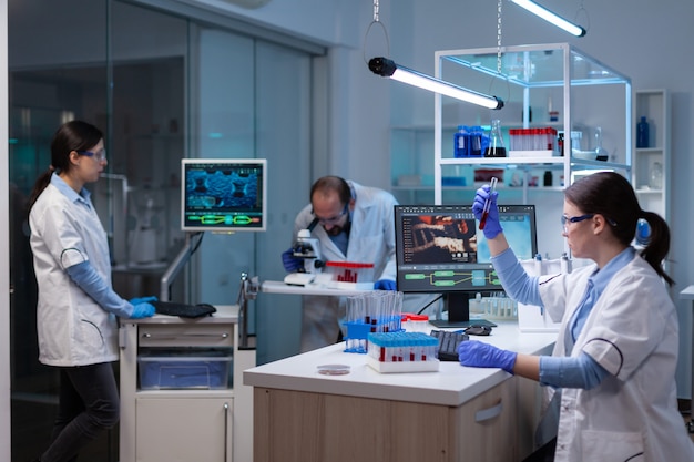 Professional doctor scientist looking in computer analysing DNA image scan