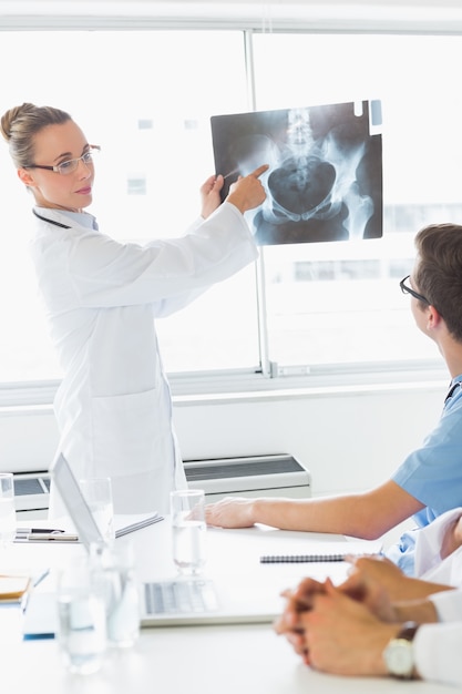 Professional doctor showing Xray to colleagues