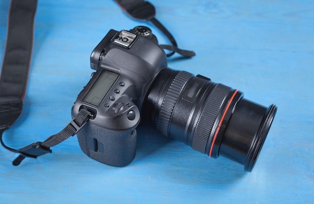 Professional DSLR camera on the blue background.