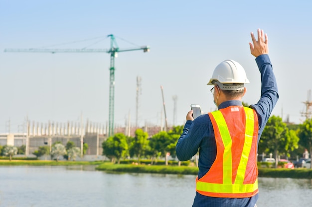 Professional engineer standing outdoors on construction site  working.