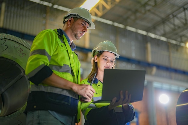 Professional engineering workers walk and check in warehouse factory