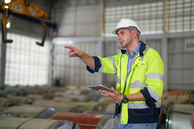 Professional engineering workers walk and check in warehouse factory