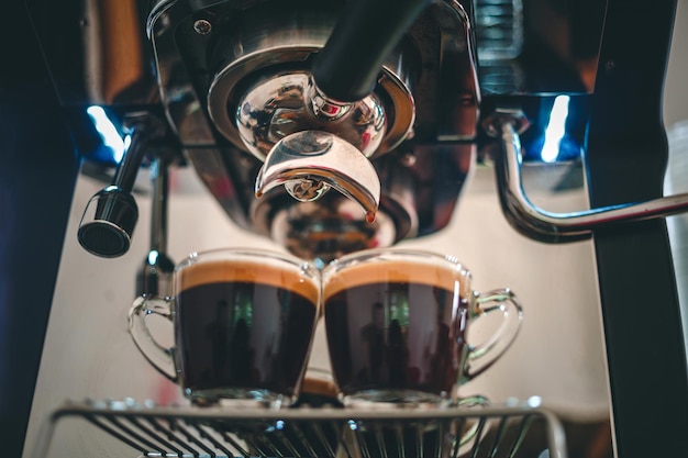 Professional espresso machine while preparing two espressos shot in a coffee shop