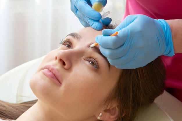 Professional eyebrow correction in spa beauty salon