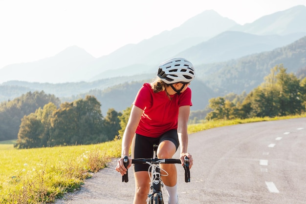 Professional female bicyclist during road cycling sprint close up