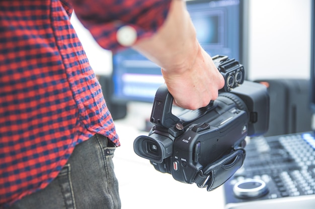 Professional film production Male filmmaker is recording with a professional movie camera Close up of camera lens