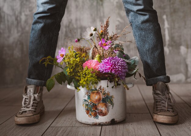 professional florist holds wild flowers composition