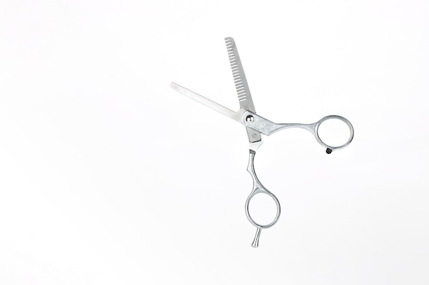 Professional flying scissors for haircuts on white background Hairdresser scissors on white background with copy space for text