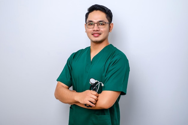 Professional goodlooking asian doctor medical worker in glasses and scrubs cross arms and smiling