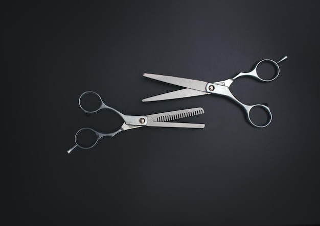 Professional Haircutting Scissors Open hairdresser scissors on a black background Professional tool for hairdressers scissors