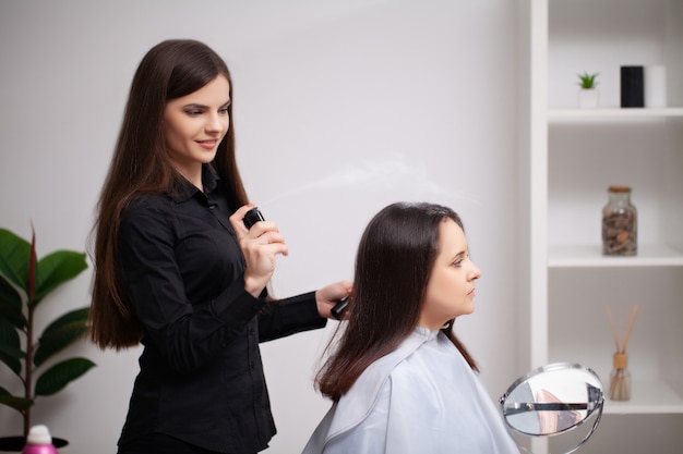 Professional hairdresser does hair care procedures at home