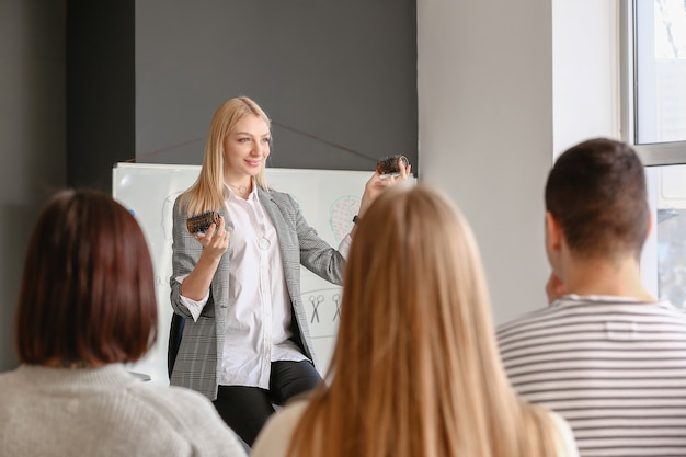 Professional hairdresser teaching young people in office