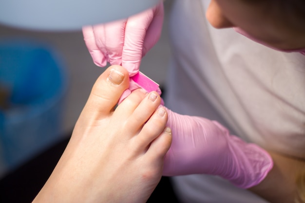 Professional hardware pedicure. procedure for the preparation of nails before applying nail polish. 