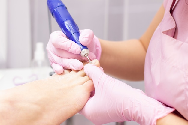 Professional hardware pedicure using an electric machine.