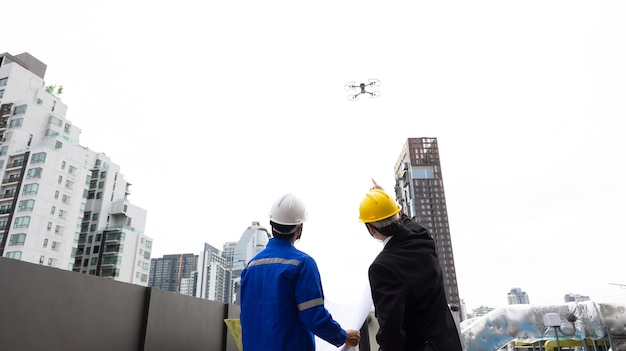 Professional inspection engineering use drone for survey
building under construction site