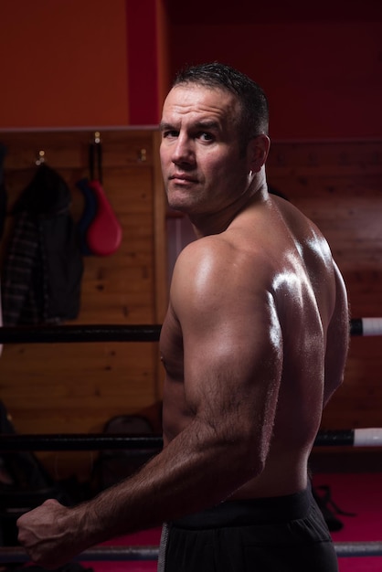 professional kickboxer with hands in martial arts position training for the fight in the training ring