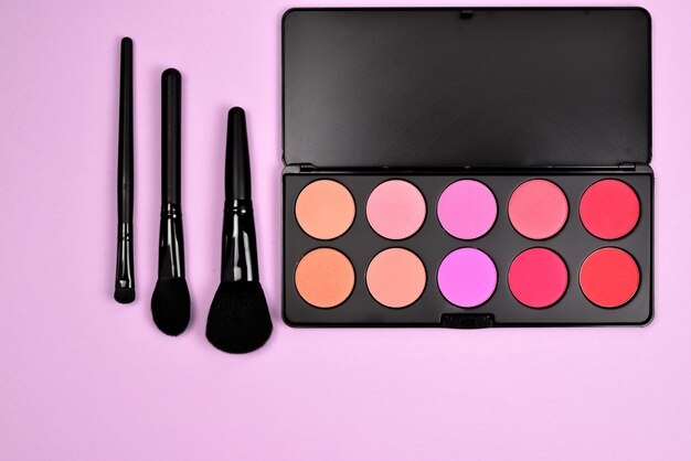 Professional makeup products with cosmetic beauty products, blushes, eye liner, eye lashes, brushes and tools.