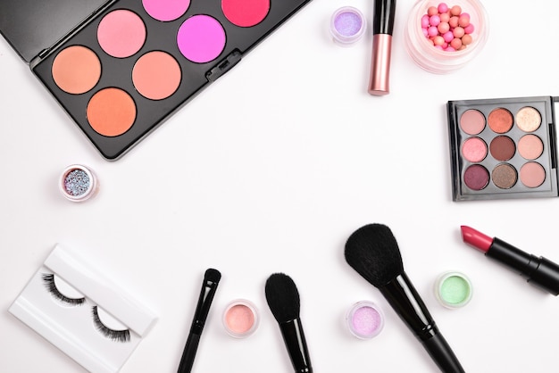 Professional makeup products with cosmetic beauty products, blushes, eye liner, eye lashes, brushes and tools.