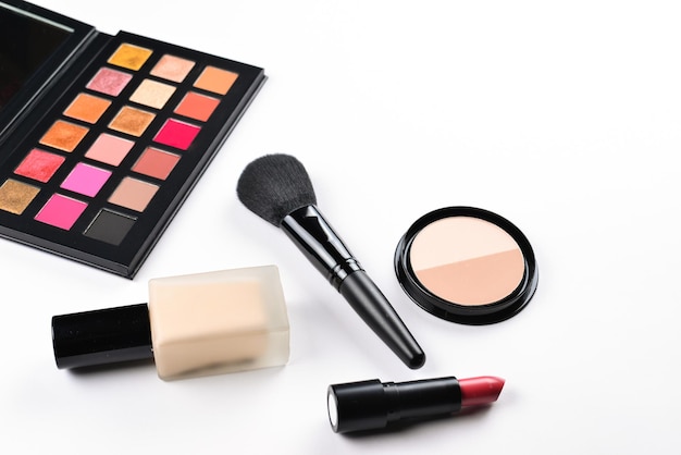 Professional makeup products with cosmetic beauty products foundation lipstick eye shadows eye lashes brushes and tools