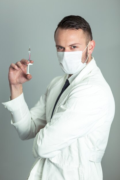 Professional male doctor holding vaccine