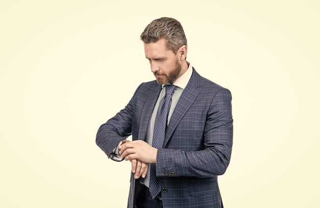 Professional man in formal suit check time by wrist watch isolated on white punctuality