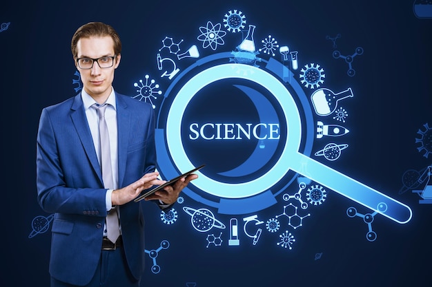 a professional man holding a digital tablet stands before a vibrant sciencethemed graphic with icons and the word science