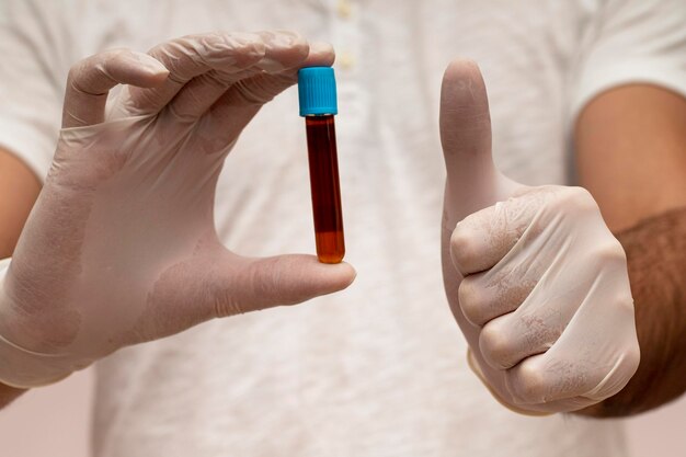 Professional man scientist is showing blood test tube with confidence