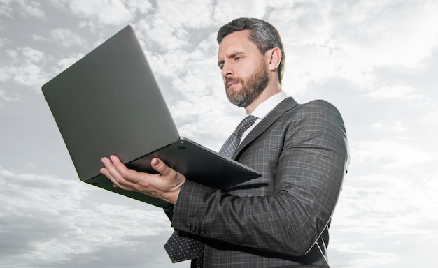 Professional man using computer Successful businessman working on computer Serious computer user