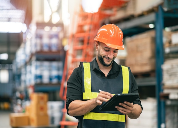 Professional manager man employee using tablet check stock working at warehouse Worker wearing.