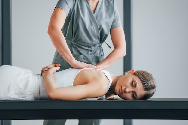 Professional massage Woman is in health center getting help by doctor
