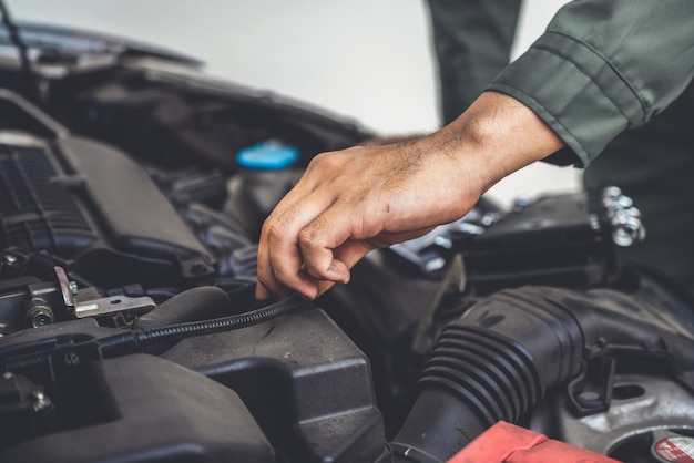 Professional mechanic hand providing car repair and maintenance service