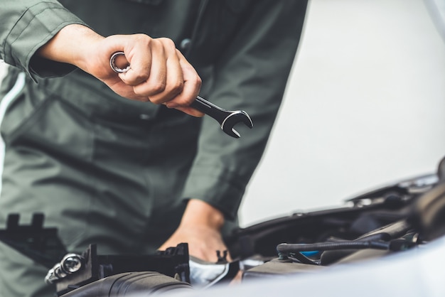 Professional mechanic hand providing car repair and maintenance service