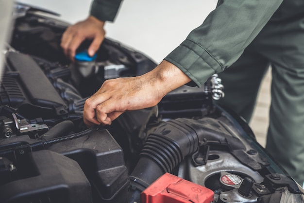 Professional mechanic hand providing car repair and maintenance service