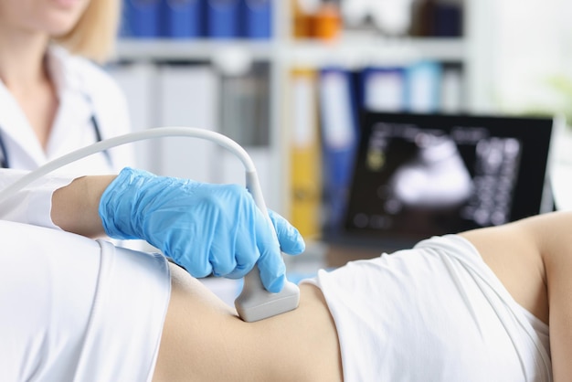 Professional medical worker examine clients body with ultrasound tool