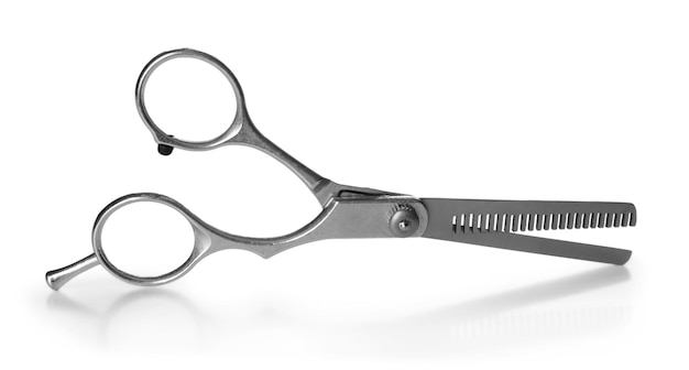 Professional metal scissors in open position isolated on white close up