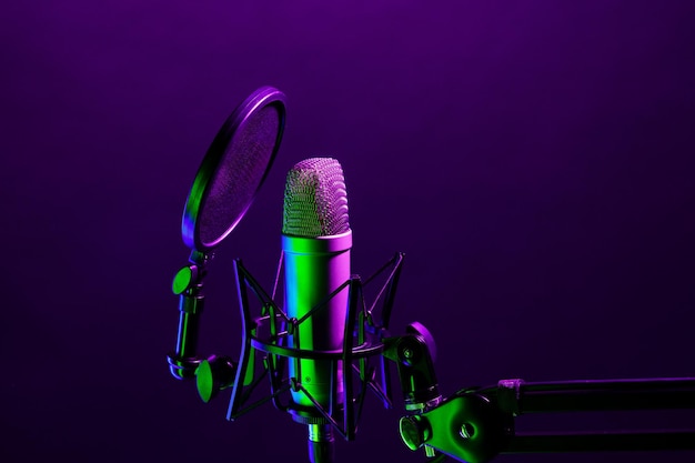 Professional microphone against black background in studio